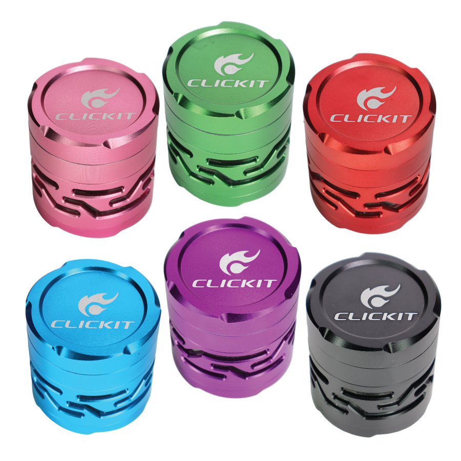 Six CLICKIT metallic grinders with patterned side cutouts and branded lids in pink, green, red, blue, purple, and black on a white background.